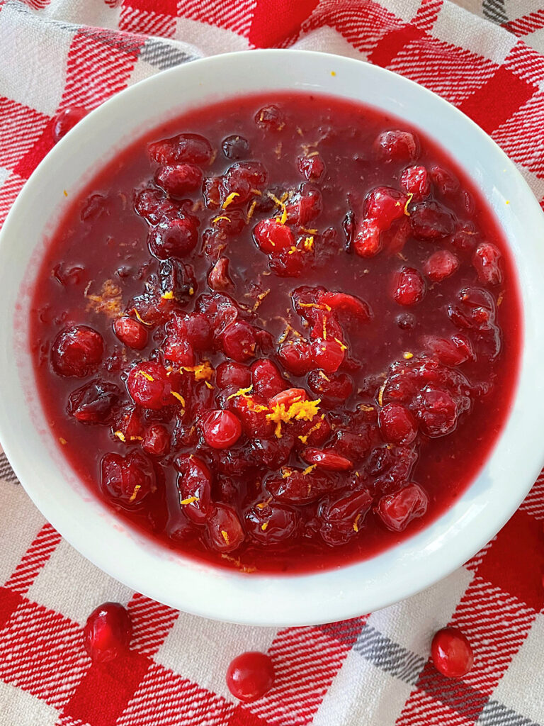 A bowl of cranberry sauce with orange juice.