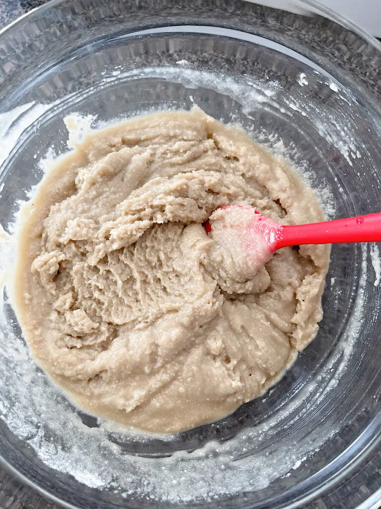 Apple crisp topping made of cake mix and butter in a mixing bowl.