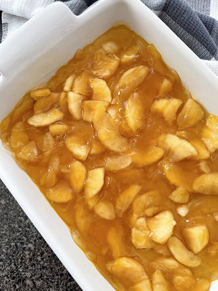 Apple pie filling in the bottom of a baking dish.