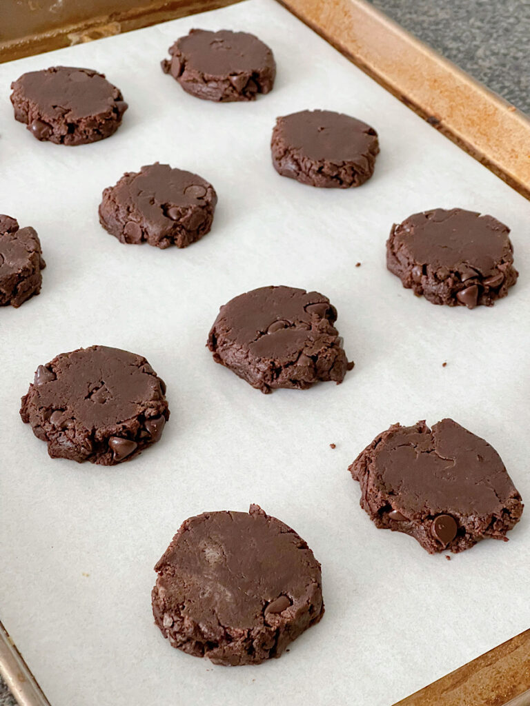 Unbaked brownie cookies on a baking sheet.