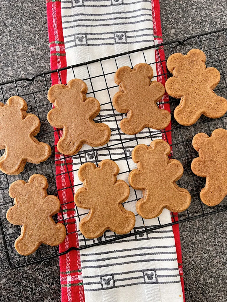 Baked Mickey Mouse gingerbread cookies on a cooling rack.