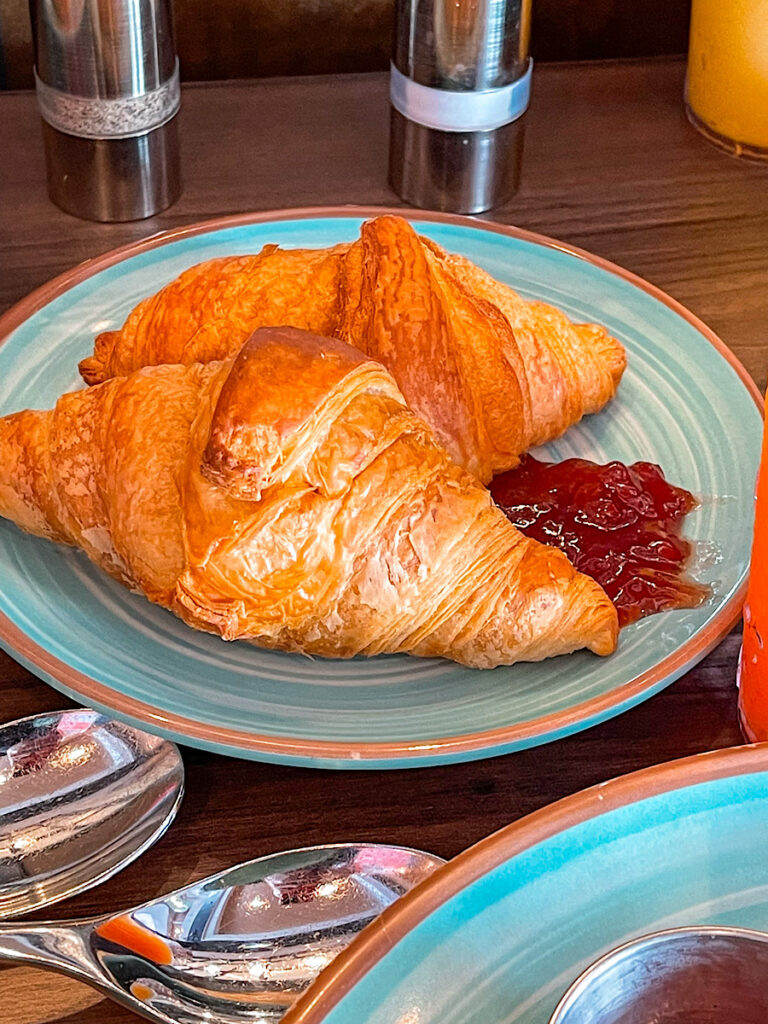 Two Disney Cruise croissants on a blue plate from Marceline Market.