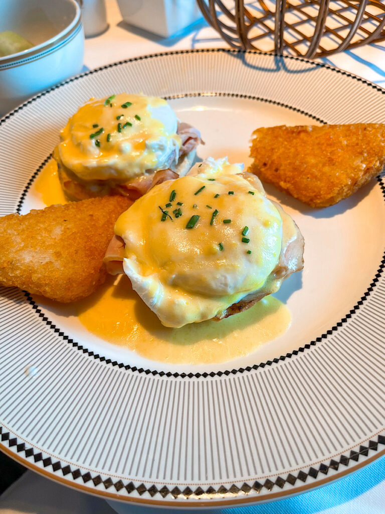 Eggs Benedict and hash browns from the breakfast menu on the Disney Wish.
