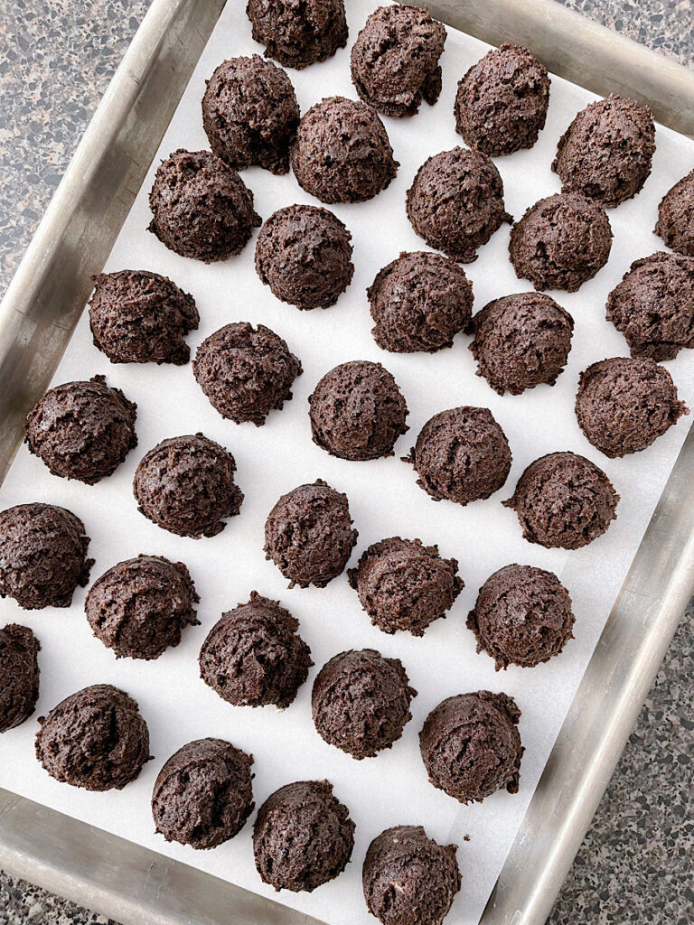Oreo truffle balls on a baking sheet.