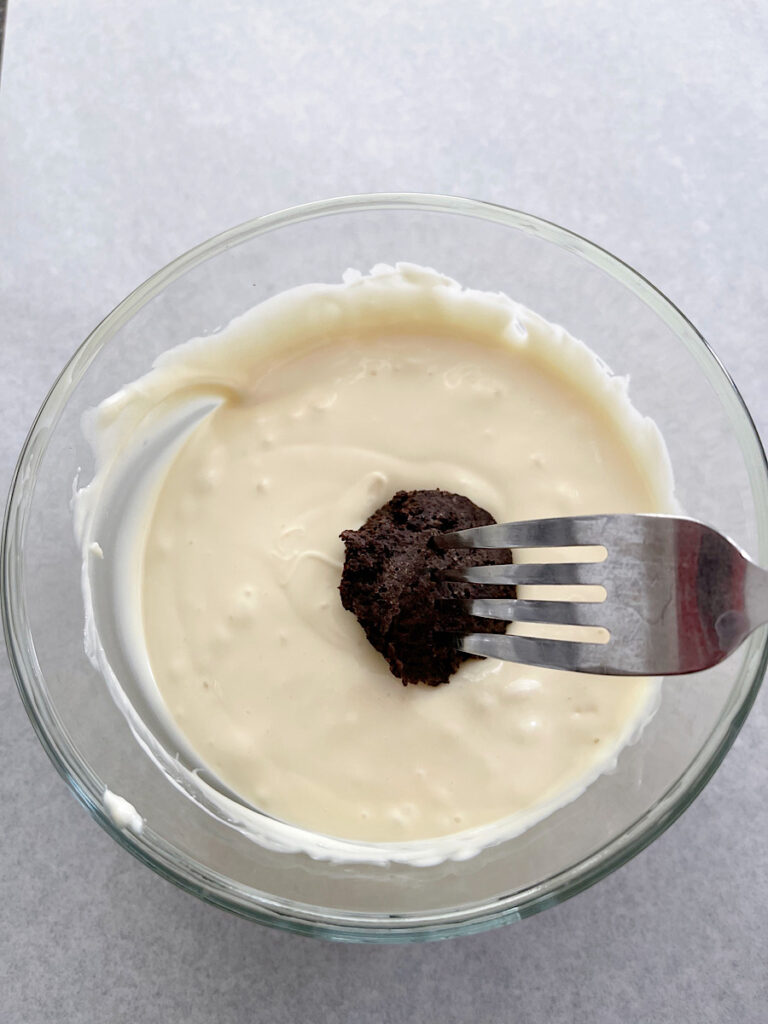 An OREO ball dipped in white chocolate.