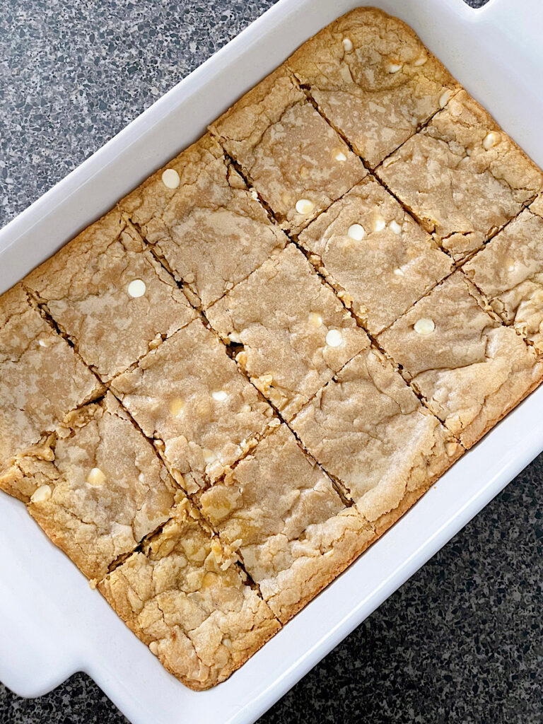 Blondies in a baking dish cut into 15 squares.