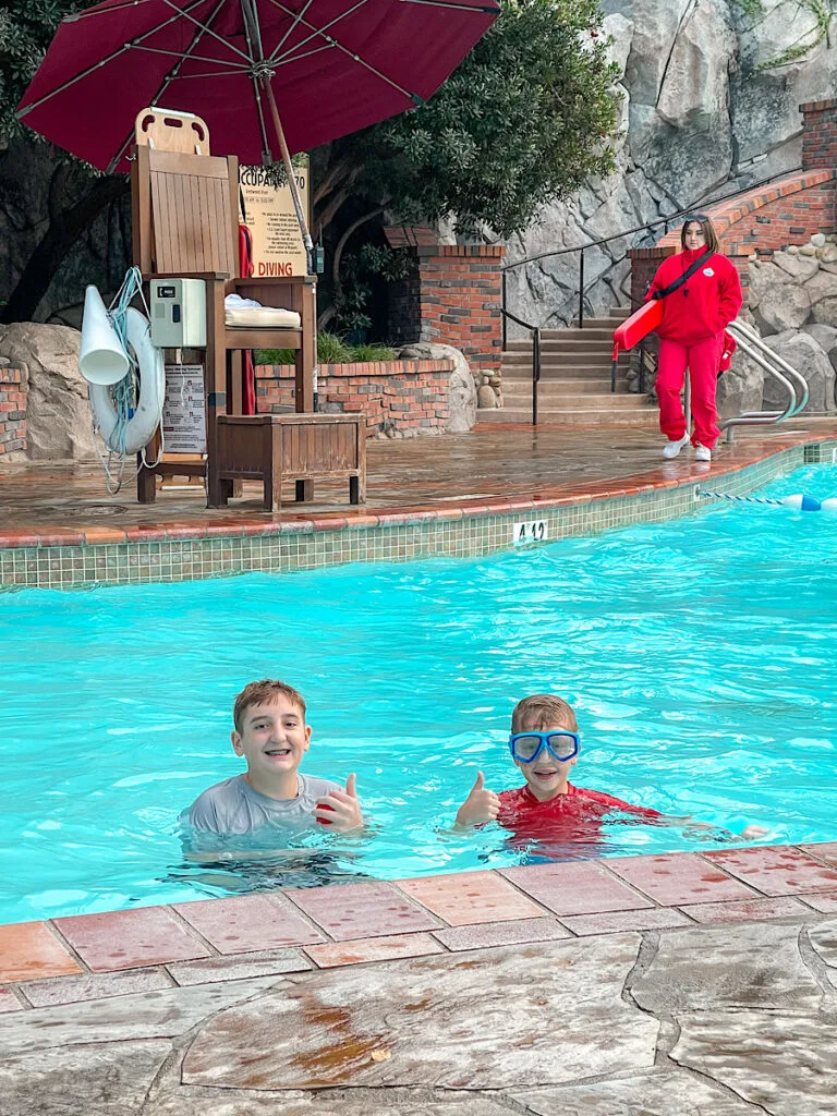Two kids in the pool at Disney's Grand Californian Hotel.