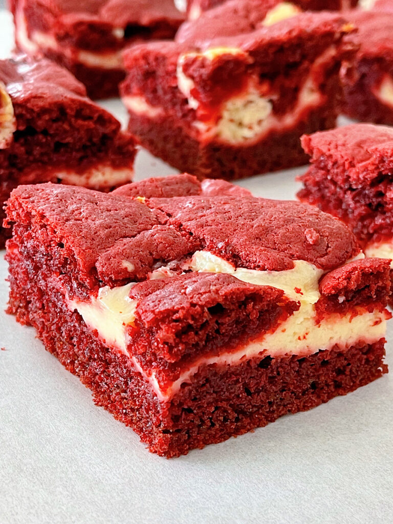 Red velvet brownies on parchment paper.