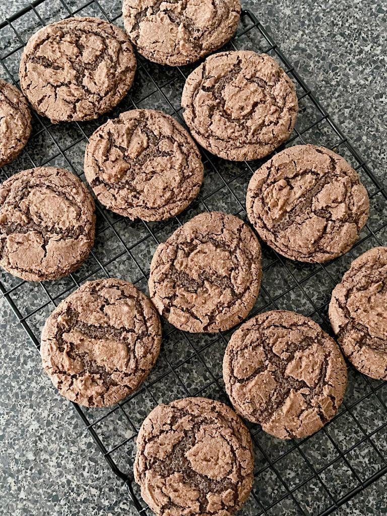 Baked hot chocolate cookies on a cooling rack.