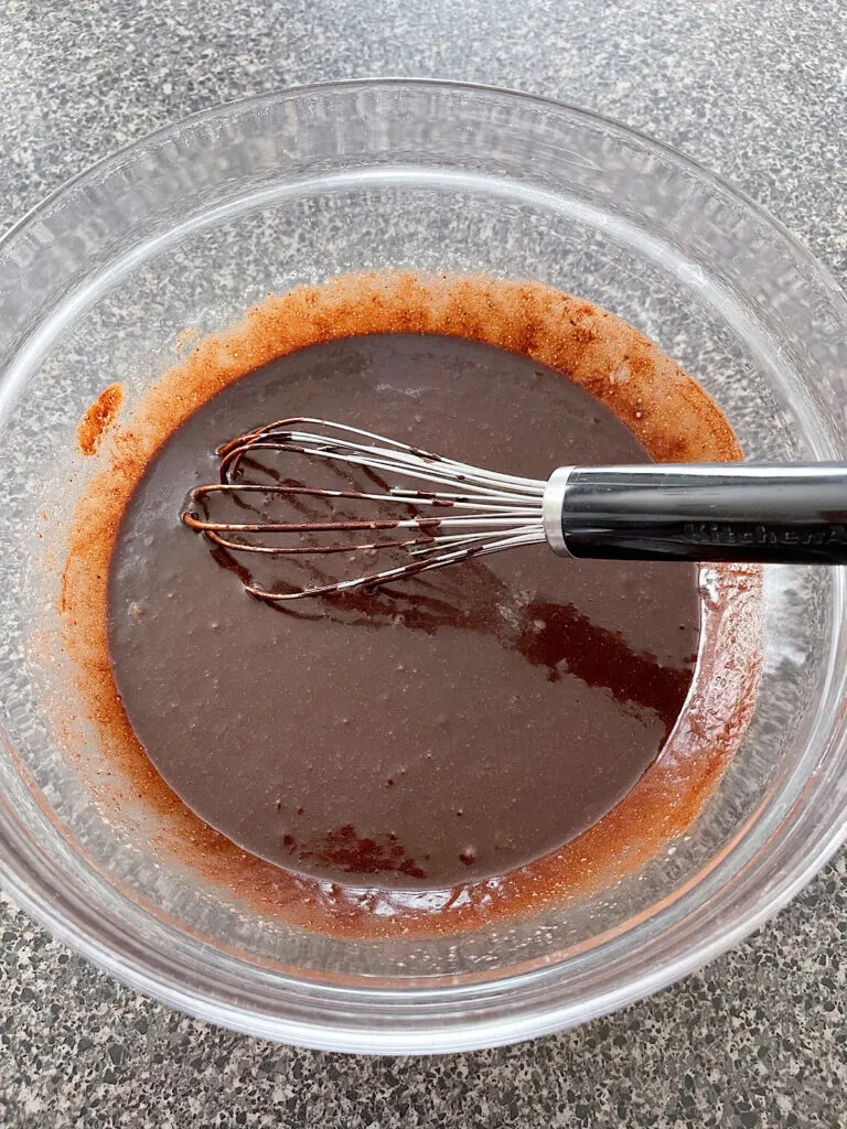 Wet ingredients for brownies in a mixing bowl.