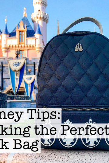 A princess Loungefly backpack in front of Sleeping Beauty Castle.