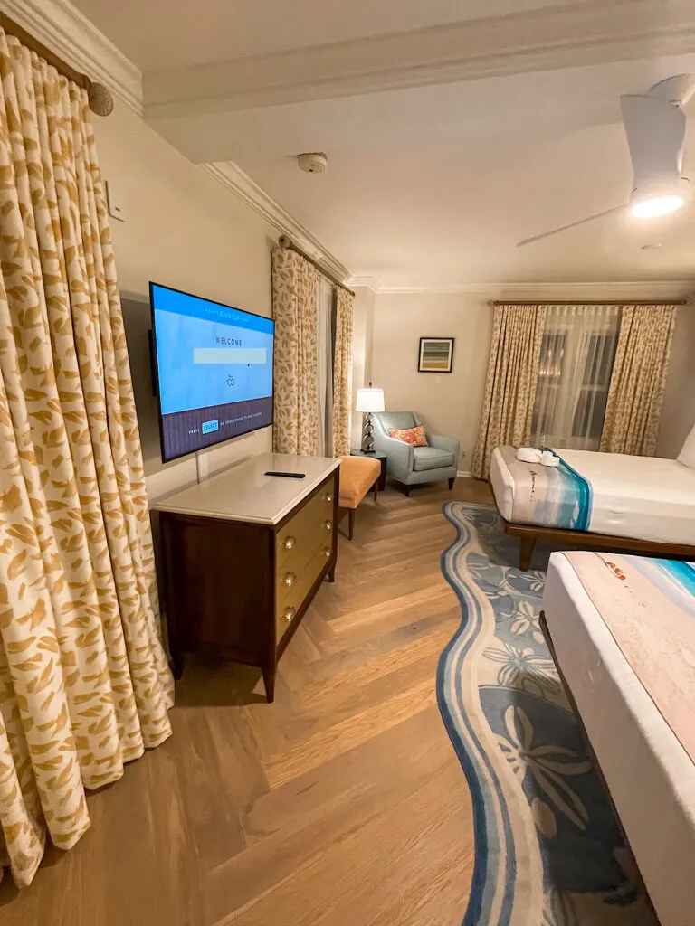 TV, chair, and beds in the second bedroom of the Newport Presidential Suite.