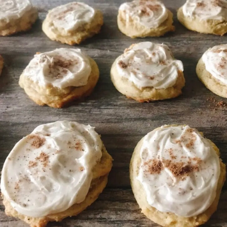 Frosted eggnog cookies sprinkled with nutmeg.