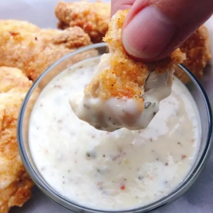 A chicken nugget dipped in Garlic Parmesan Sauce.