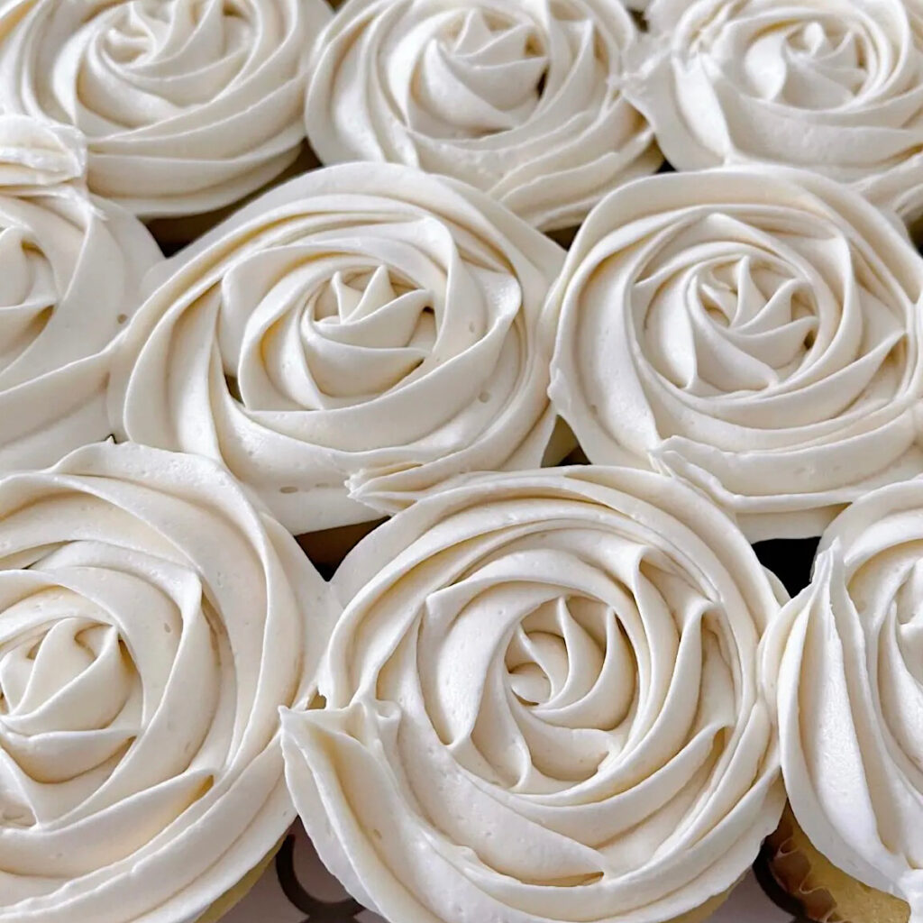 Vanilla buttercream frosting on cupcakes.