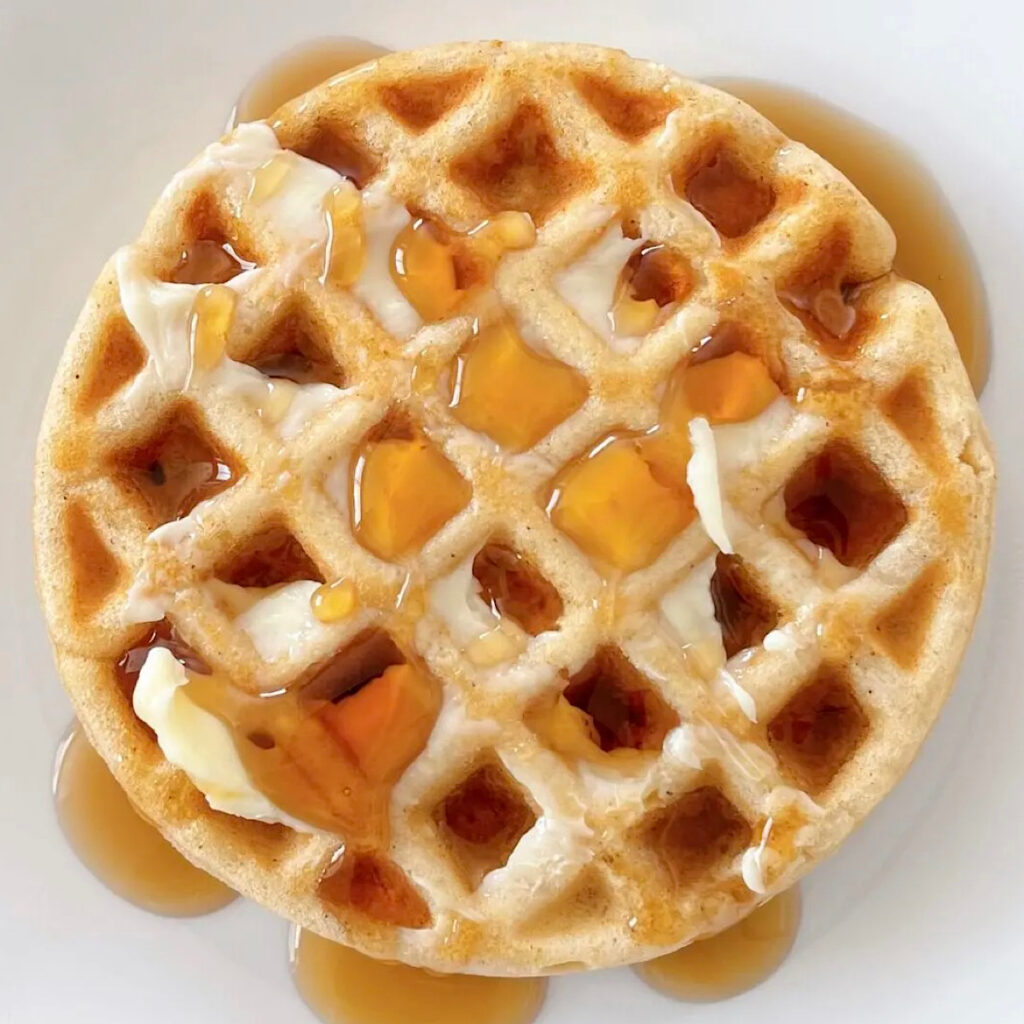 A waffle made with pancake mix topped with butter and syrup.