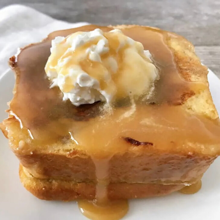 Copycat Kneader's French Toast topped with whipped cream and caramel syrup.