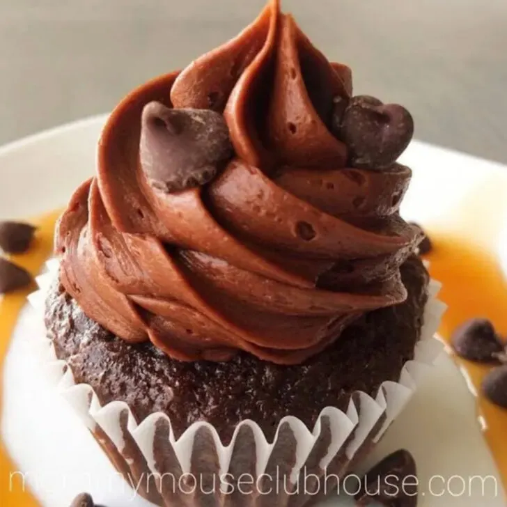 A chocolate cupcake filled with salted caramel ganahce and topped with chocolate frosting.