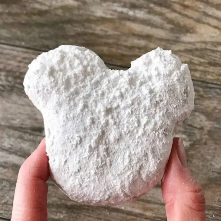 A Mickey Beignet covered in powdered sugar made with premade pizza dough.