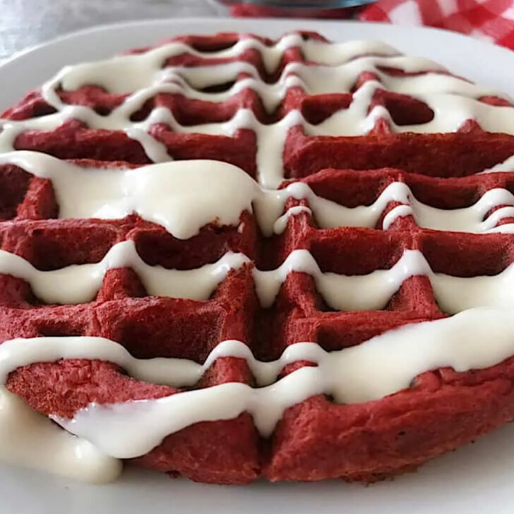 A red velvet waffle with sweet cream cheese syrup.
