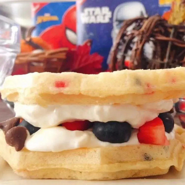 A waffle sandwich with cream cheese filling and berries.