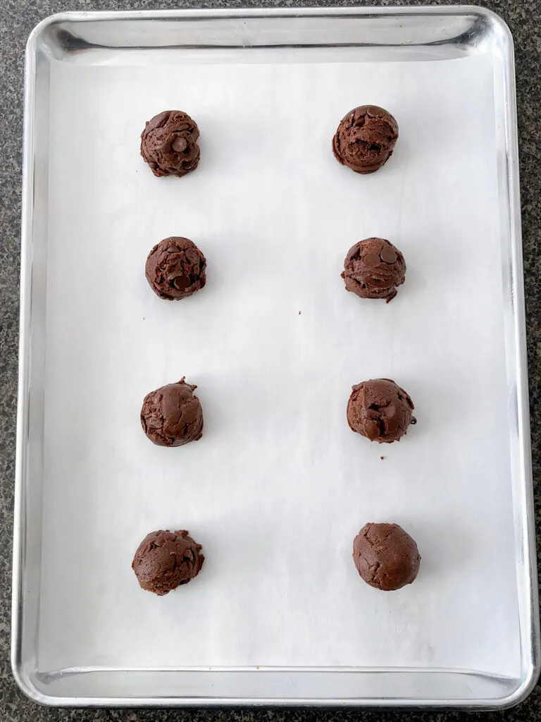German chocolate cookie dough balls on a baking sheet.