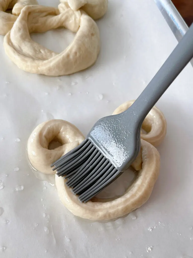 Baking soda and water brushed onto an unbaked Mickey pretzel.
