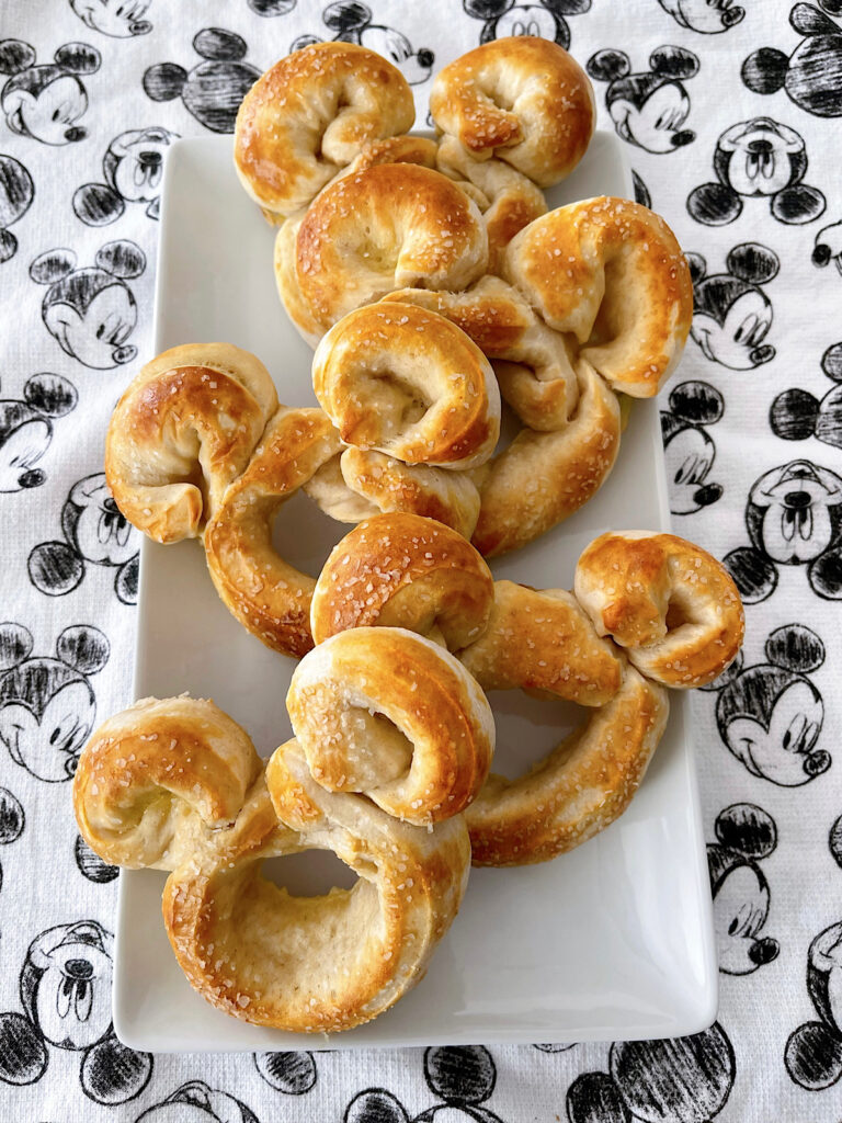 Homemade Mickey Pretzels on a Mickey Mouse kitchen towel.