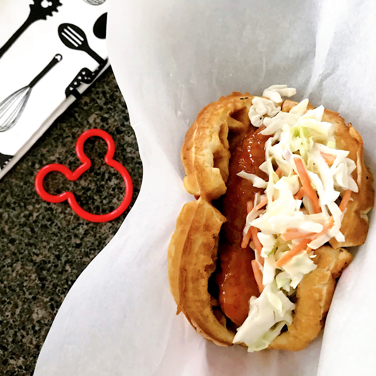 A waffle sandwich with sweet & spicy chicken and cole slaw