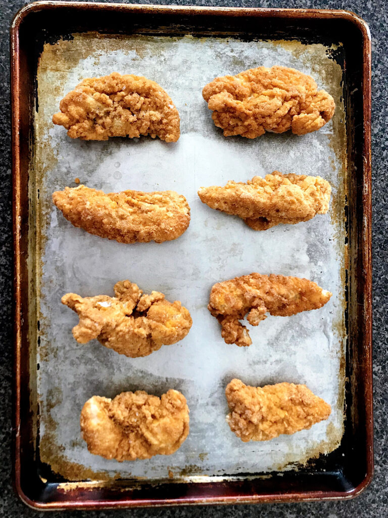 Chicken tenders on a baking sheet
