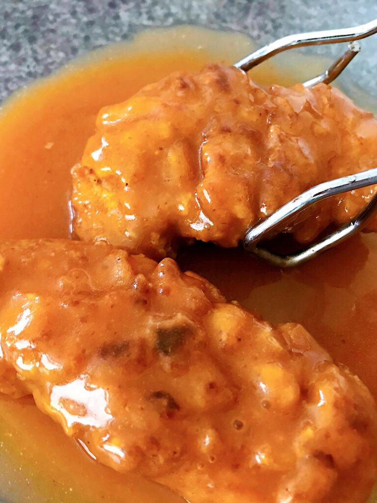 Coat the chicken tenders with sweet and spicy sauce.