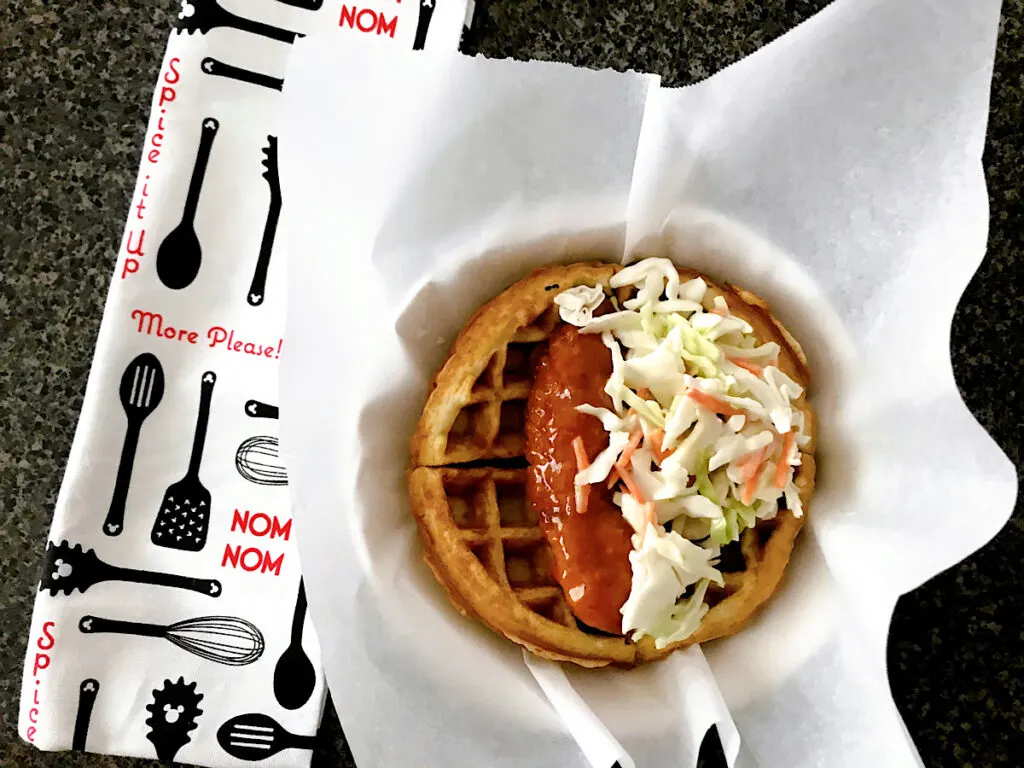 A waffle sandwich with sweet & spicy chicken and cole slaw