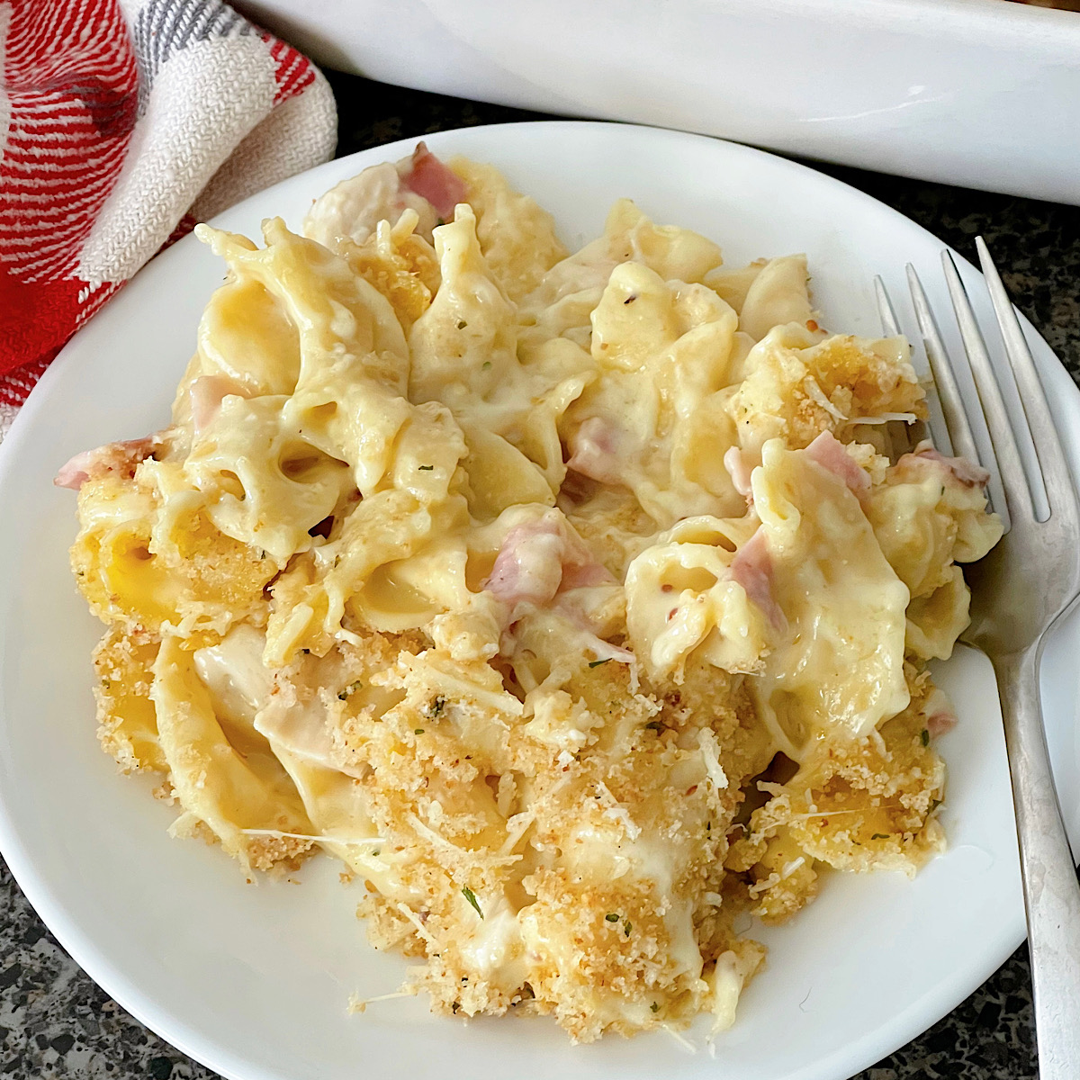 A chicken cordon bleu casserole in a white dish.