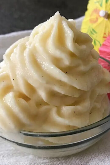 A dish of homemade Dole Whip with tropical umbrellas.