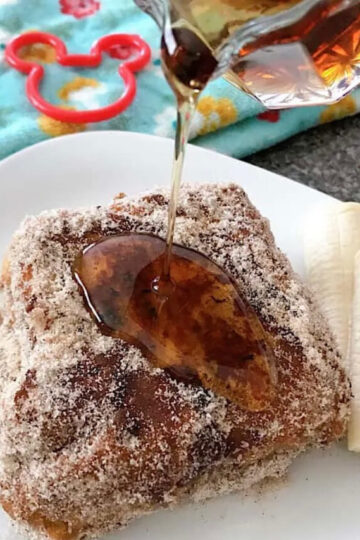 Syrup poured over Disney's Tonga Toast, French toast stuffed with bananas and covered in cinnamon sugar.
