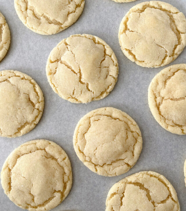 Sugar cookies on a piece of parchment paper.
