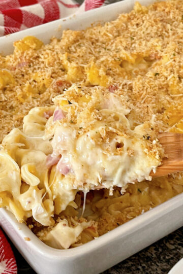 A chicken cordon bleu casserole in a white dish.
