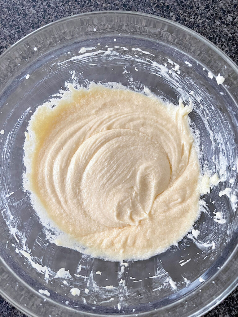 Butter, sugar, eggs, and vanilla in a bowl for vanilla cupcakes.