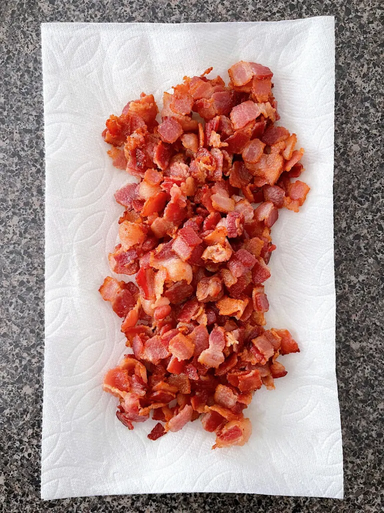 Cooked bacon on a paper towel.