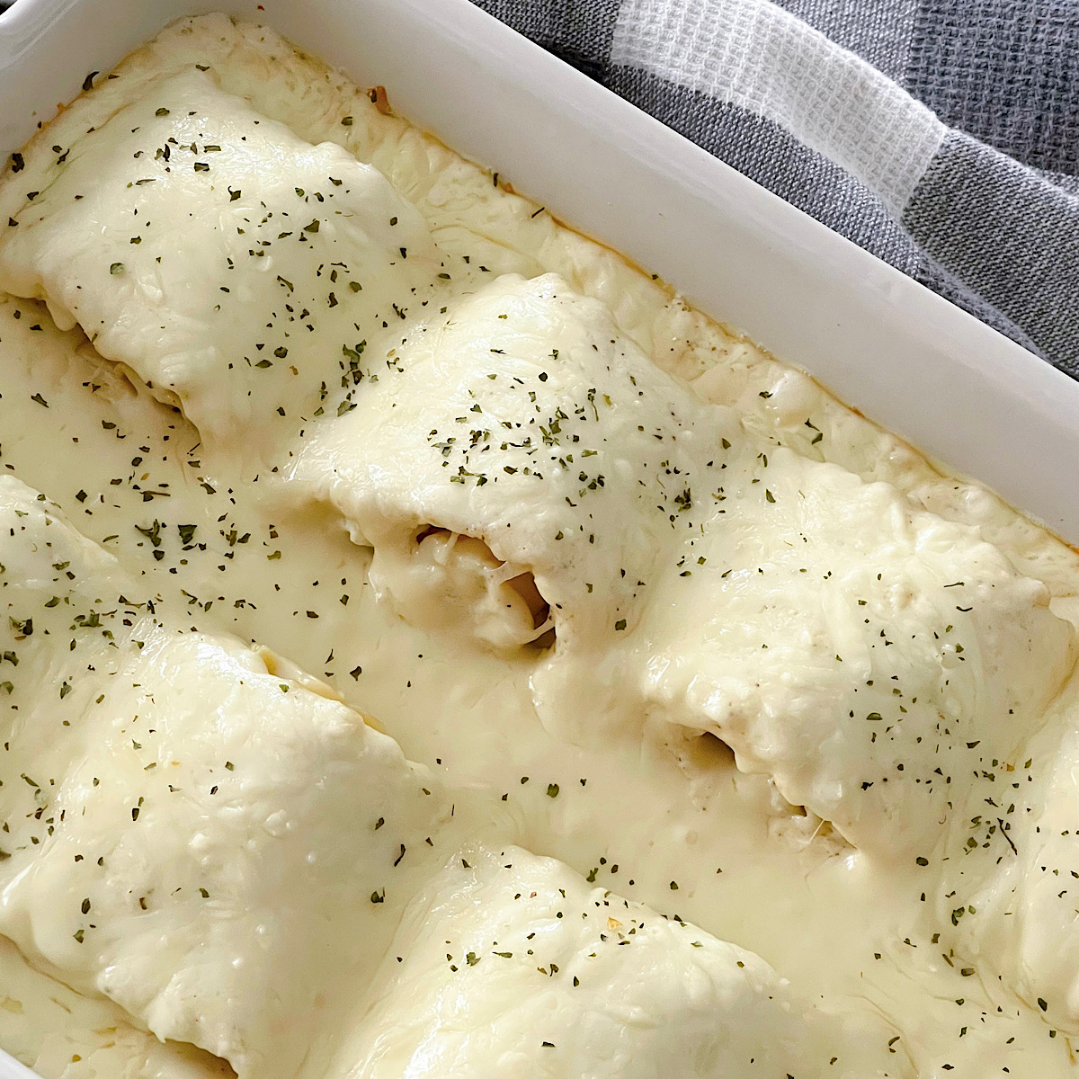 Chicken Alfredo Roll Ups in a baking dish.