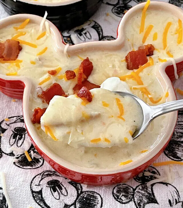 Disneyland's Loaded Baked Potato Soup in a Mickey Mouse-shaped bowl with sour cream and bacon.
