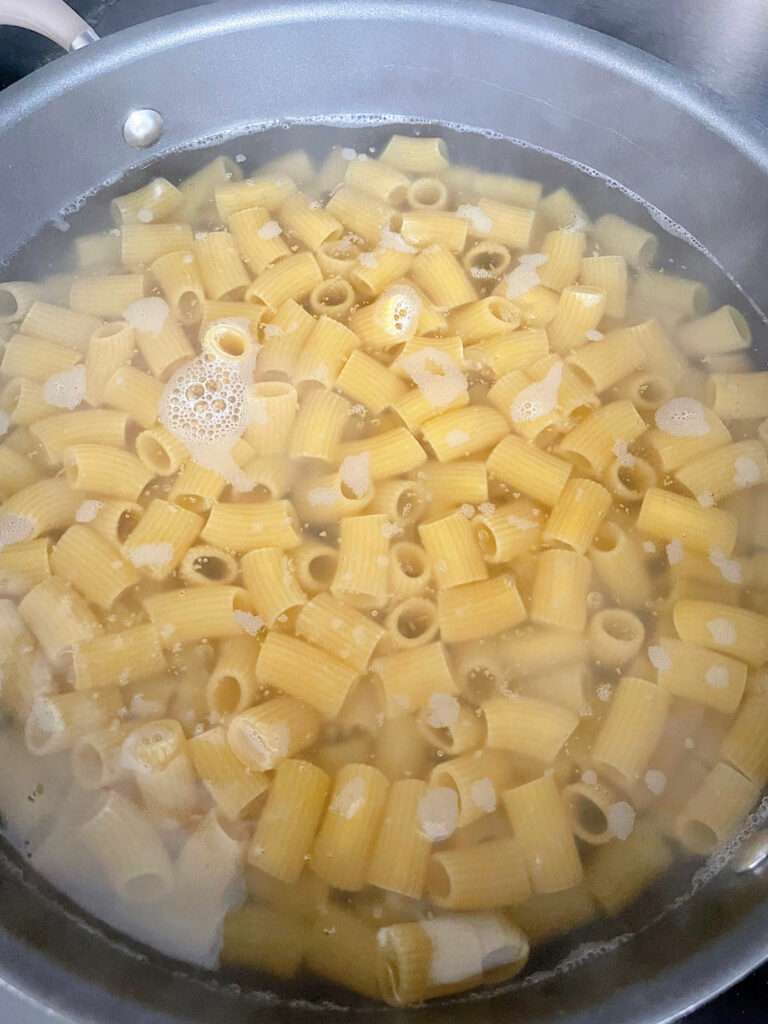 Rigatoni pasta in a pot of water.