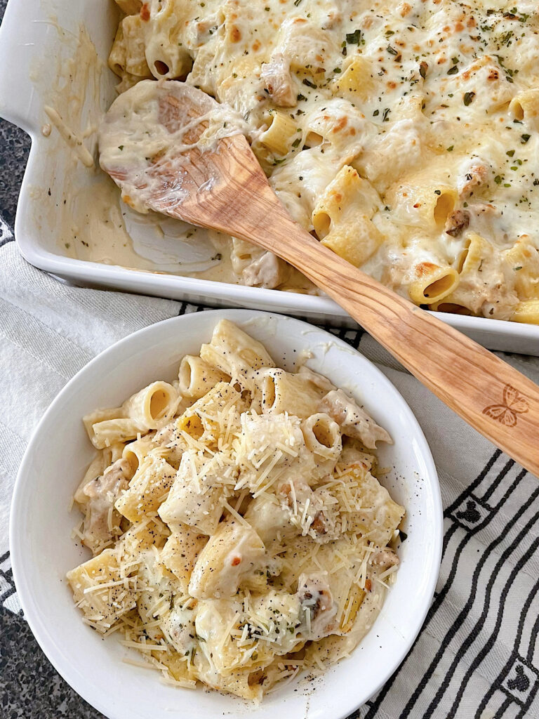 A dish of baked Garlic Parmesan Chicken Alfredo pasta.