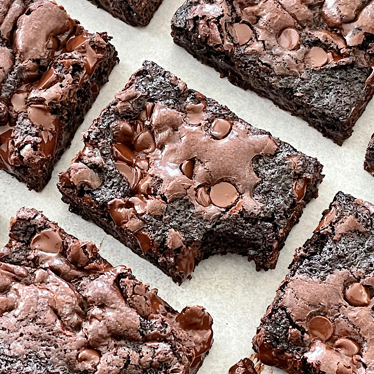 Homemade brownies on parchment paper.