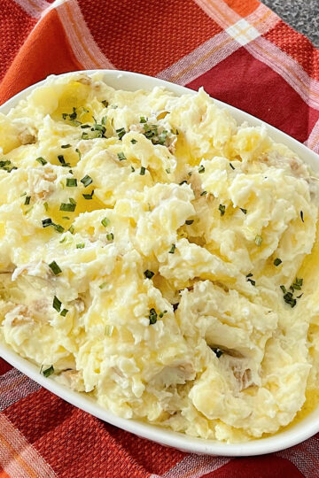 Creamy mashed potatoes made with butter, sour cream, and cream