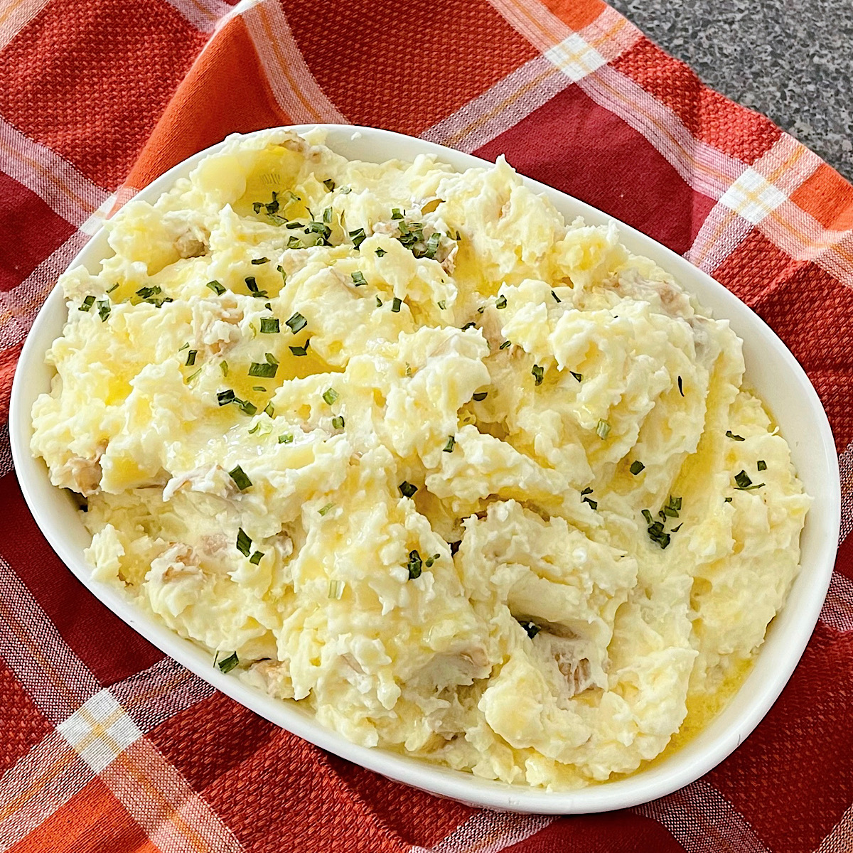 Creamy mashed potatoes made with butter, sour cream, and cream