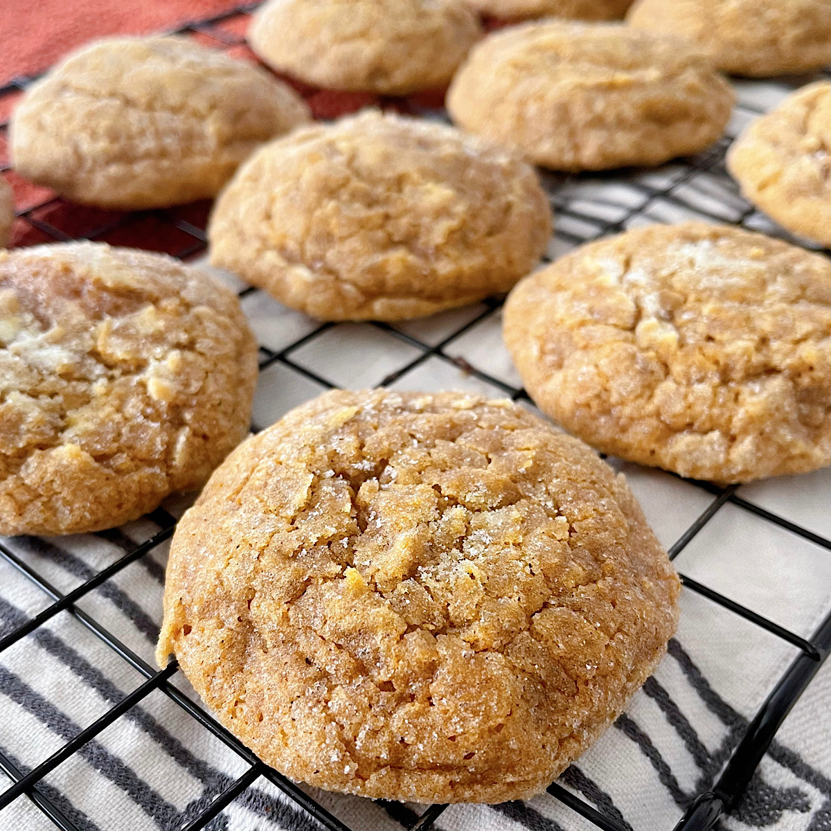 Soft pumpkin sugar cookies on a baking sheet.