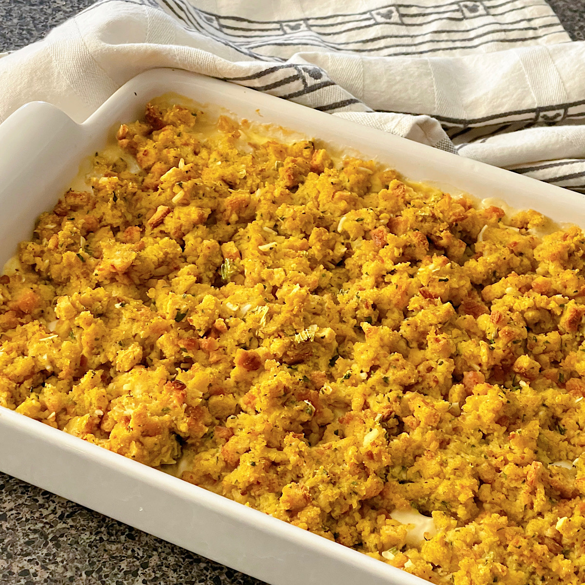Chicken and stuffing casserole in a white baking dish.