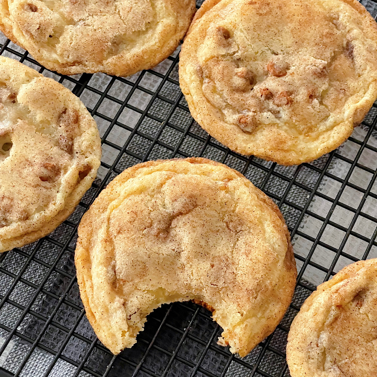 Cinnamon chip snickerdoodles on a cooling rack.