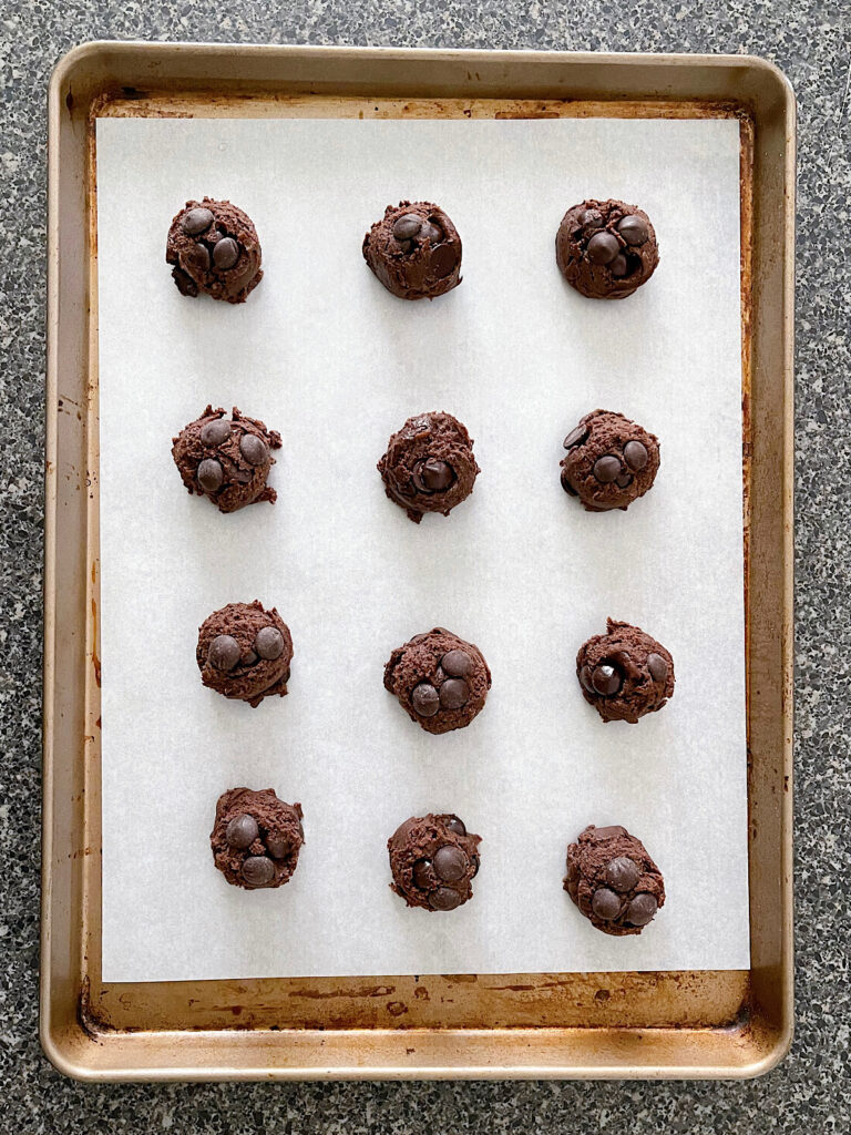 Brownie mix cookie dough balls on a baking sheet.
